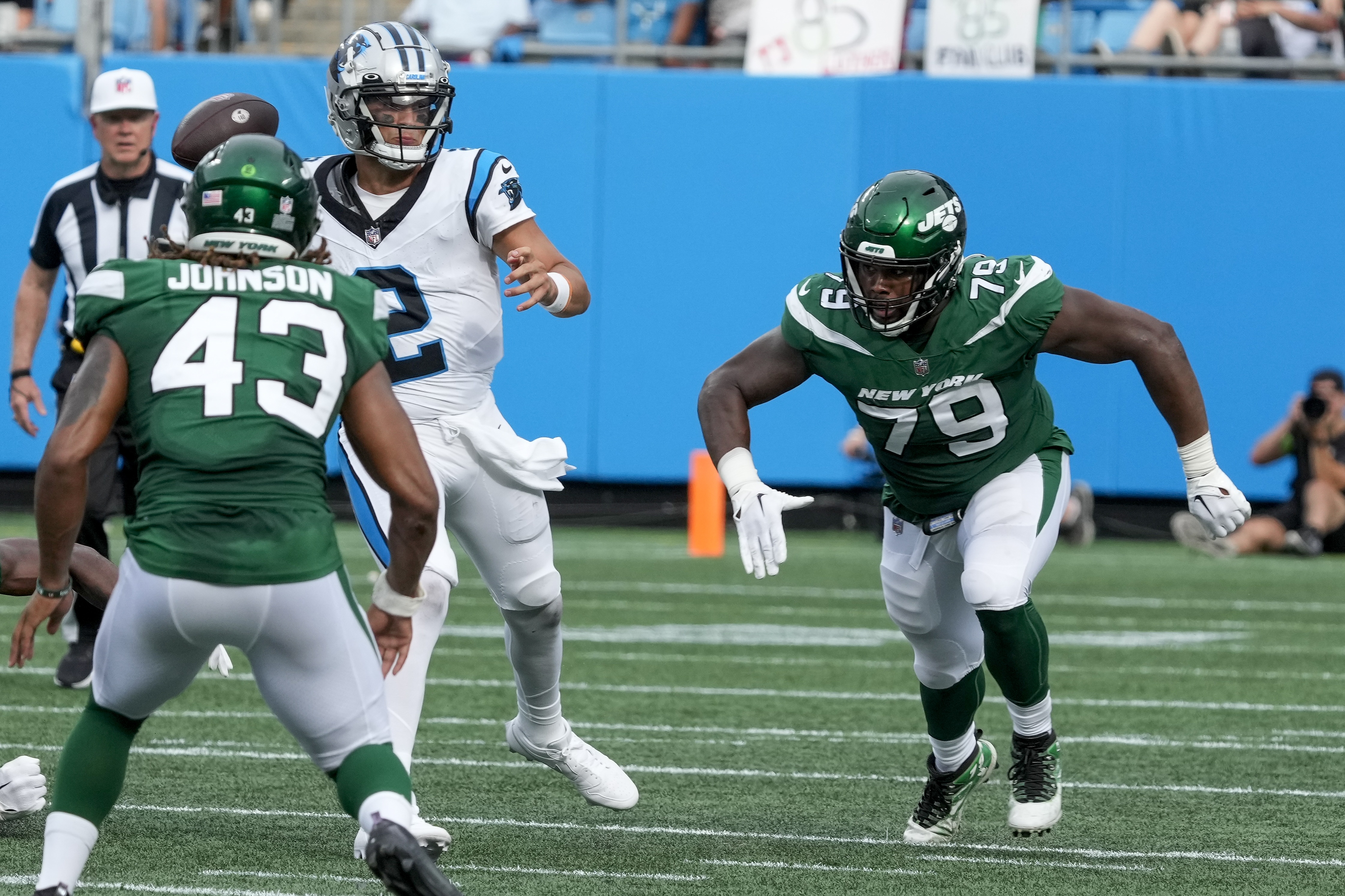 DT Tanzel Smart (79) and LB Caleb Johnson (43) defend a pass from Carolina's Matt Corral